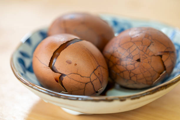 A beautifully crafted bowl filled with cracked brown eggs, exhibiting their diverse and unique textures and colors