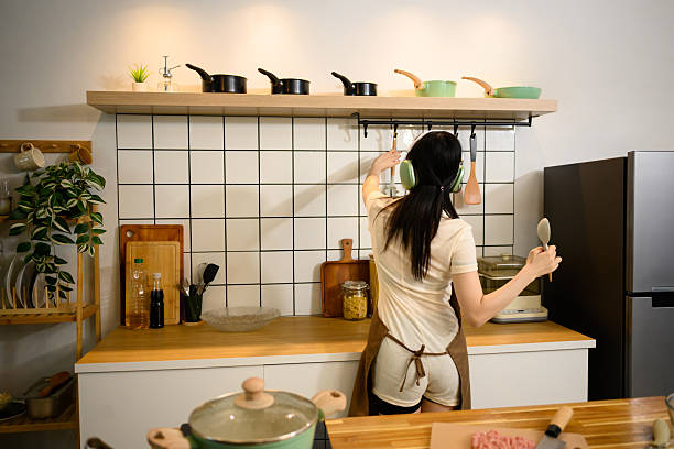 istock Young woman preparing kitchen utensils for cooking spaghetti in a kitchen 2204260484