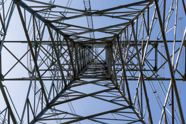 istock A low-angle shot of a high-voltage electricity pylon against a clear blue sky. 2204262789