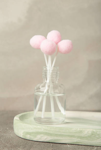 istock Air freshener on grey. White aroma diffuser bottle with sticks. Minimalism. Top view 2204263841