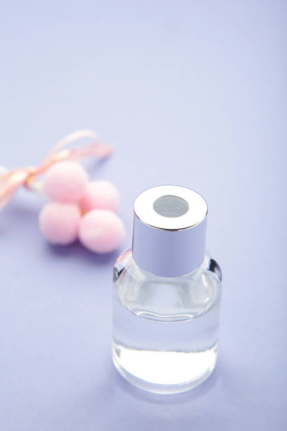A close-up shot showcases four bottles of fragrant oils arranged on a white stand, offering a variety of scents for customers to explore.