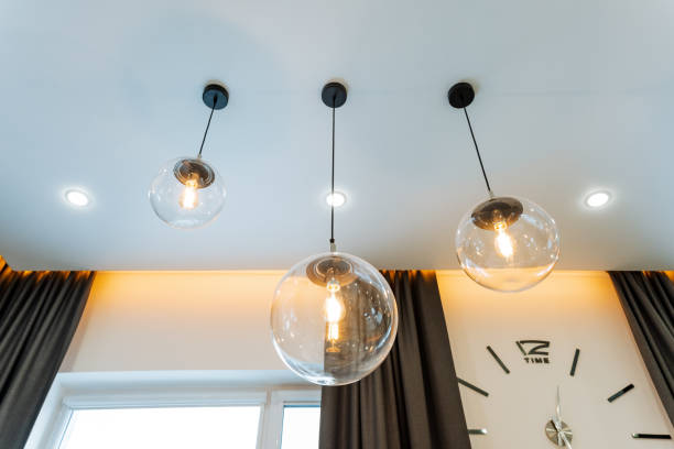 istock Inside the room, there is a clock beautifully mounted on the wall, while three stylish lights hang gracefully from the ceiling, enhancing the ambiance of the space with their glow 2204266131