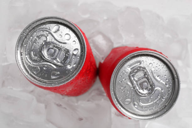 istock Energy drinks in wet cans on ice cubes, flat lay 2204267537