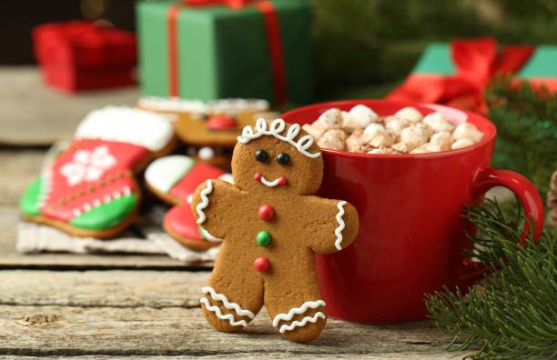 istock Tasty gingerbread man cookie and cocoa with marshmallows on wooden table. Space for text 2204267539