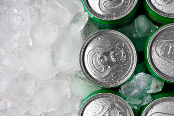 istock Energy drinks in wet cans and ice cubes, flat lay. Space for text 2204267541