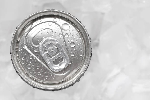 istock Energy drink in wet can on light background, top view. Space for text 2204267673