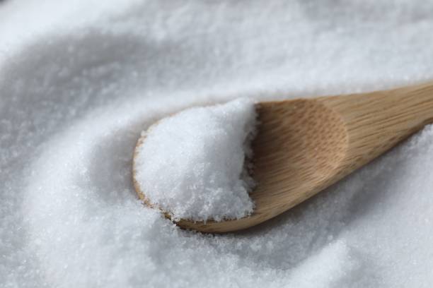 istock Wooden spoon on white sea salt, closeup 2204268651