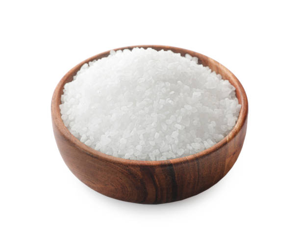 istock Natural salt in wooden bowl isolated on white 2204268751