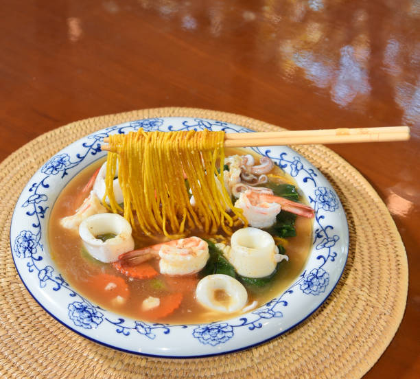 istock Crispy egg noodle with gravy and seafood 2204269734