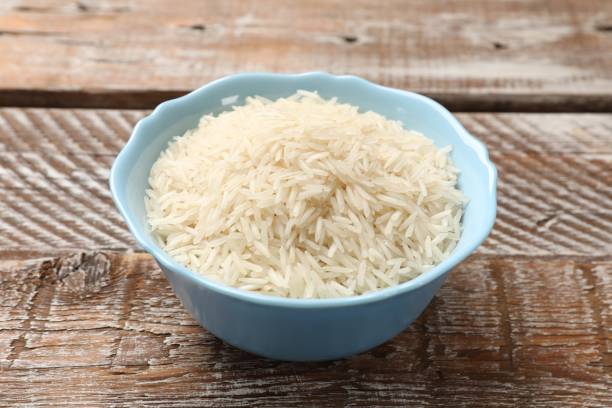 istock Raw basmati rice in bowl on wooden table 2204270474