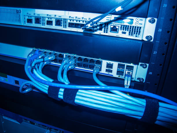 istock Detailed View of Network Switches and Cables in Data Center Setup 2204271431