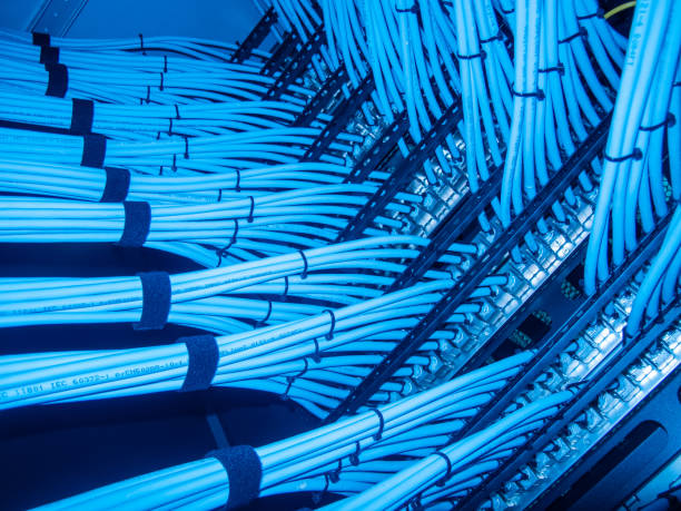 istock Tangle of Bright Blue Ethernet Cables in Server Room Rack 2204272225