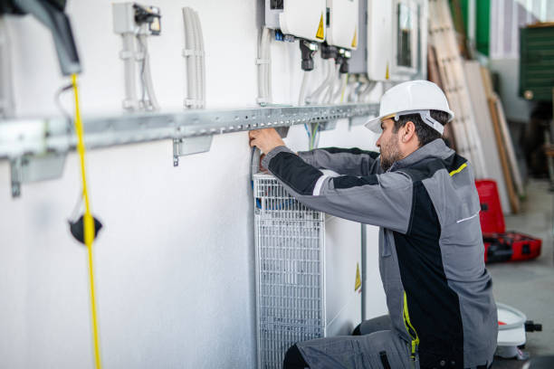 istock Electrician installing solar panel system, wiring inverter and electric box 2204272240