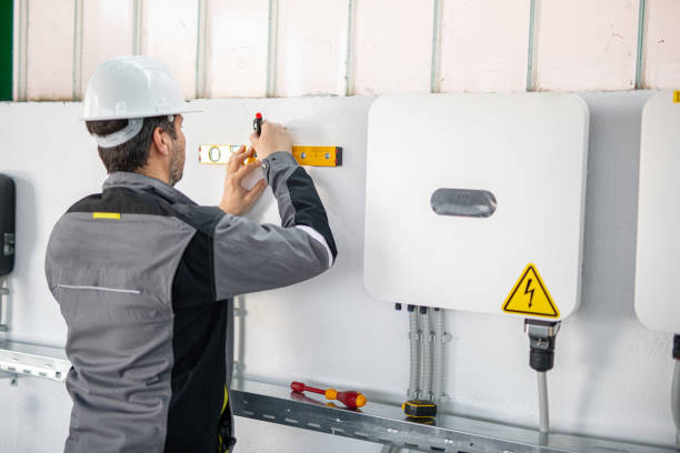 istock Electrician installing solar panel system, wiring inverter and electric box 2204272249