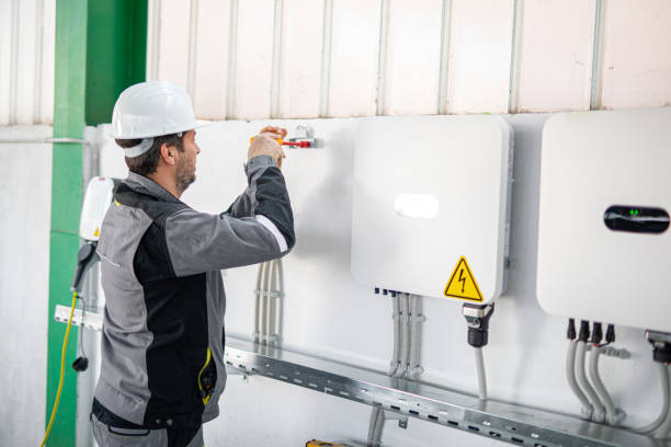 istock Electrician installing solar panel system, wiring inverter and electric box 2204272411