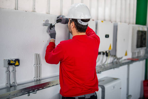 istock Electrician installing solar panel system, wiring inverter and electric box 2204272519