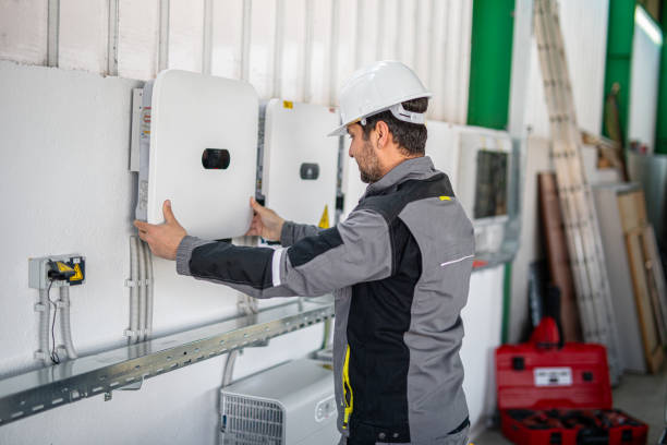 istock Electrician installing solar panel system, wiring inverter and electric box 2204272606