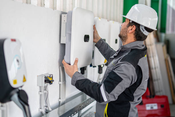 istock Electrician installing solar panel system, wiring inverter and electric box 2204272661