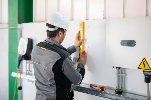 istock Electrician installing solar panel system, wiring inverter and electric box 2204272756