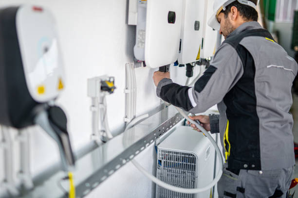 istock Electrician installing solar panel system, wiring inverter and electric box 2204272797