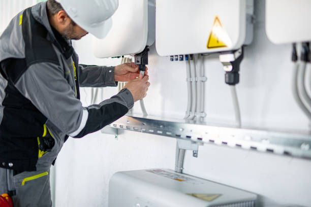 istock Electrician installing solar panel system, wiring inverter and electric box 2204272941