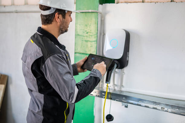 istock Engineer using a digital tablet to examine electric car charging station 2204273356