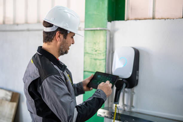 istock Engineer using a digital tablet to examine electric car charging station 2204273363