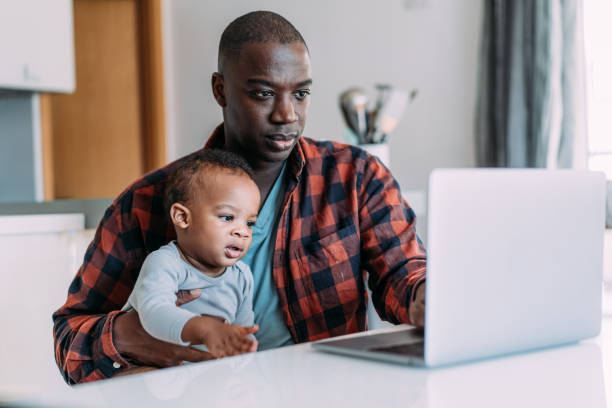 istock Father and baby working at home. 2204274617