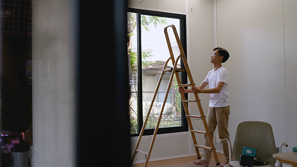 istock Asian young man is measuring a window to install curtains. House working. 2204276067