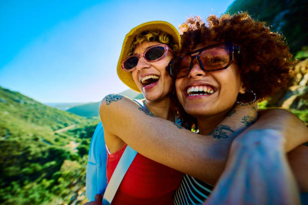 istock Two young women embracing and smiling during hiking trip 2204276593