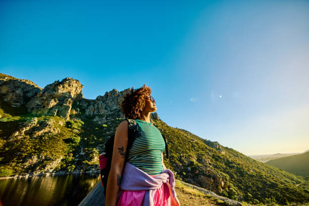 istock Gen Z female backpacker hiking and enjoying mountain scenery 2204276606