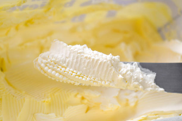 istock Margarine on knife. Soft butter. 2204278875