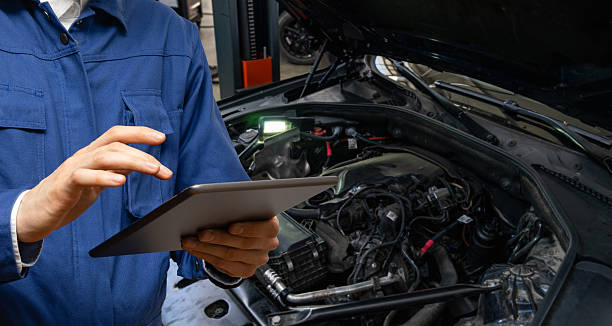 istock Serviceman with tablet checks car software in car service. 2204281138