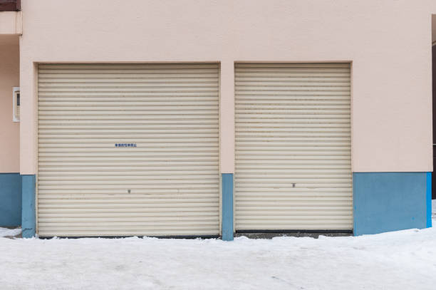 istock Two closed garage doors on a building with snow on the ground 2204281771