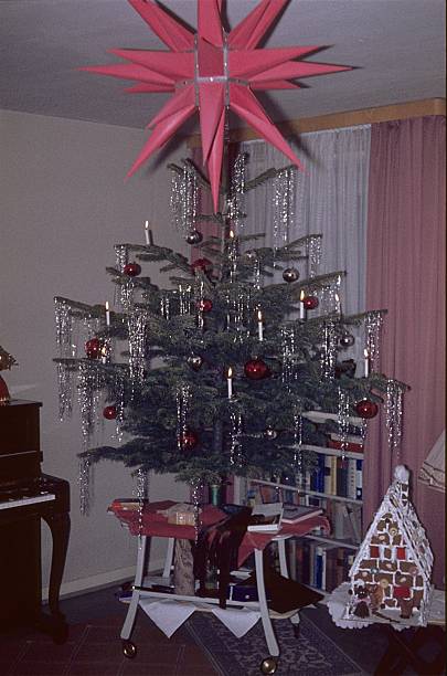 istock Christmas tree with gingerbread house and Christmas star 2204283284
