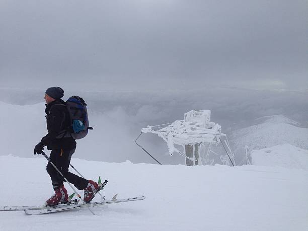 Kosice, Slovakia – March 08, 2016: A skier stands atop a snowy mountain in Slovakia