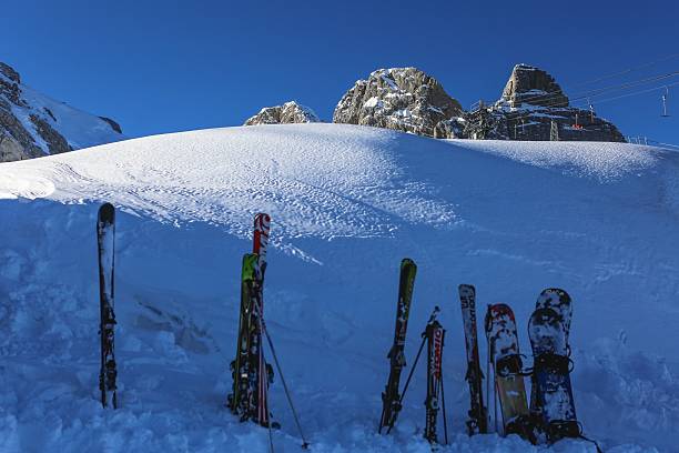 aerial view of shadows of skiers on snow on a ski slope in various positions as in a shadow theater