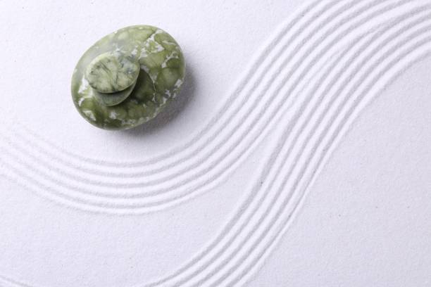 istock Zen garden stones on white sand with pattern, top view. Space for text 2204286282