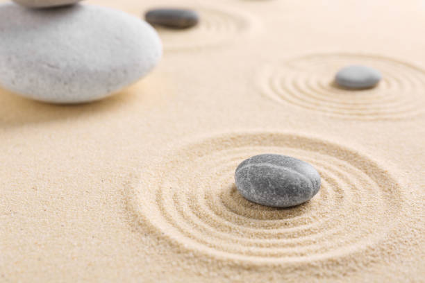 istock Zen garden stones on sand with pattern, closeup. Space for text 2204286381