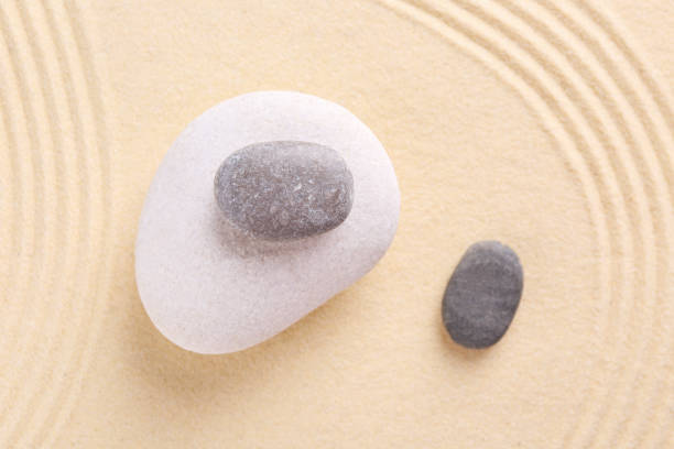 istock Zen garden stones on sand with pattern, flat lay 2204286511