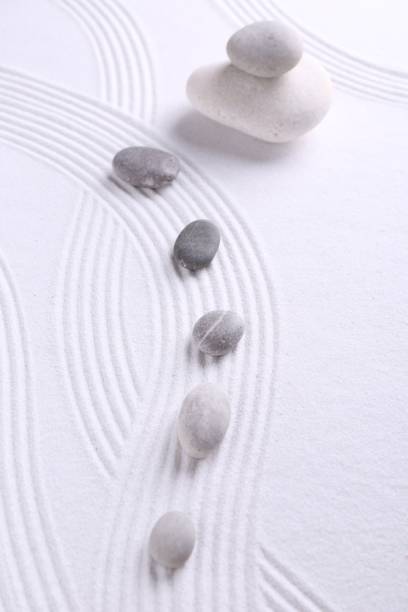 istock Zen garden stones on white sand with pattern, flat lay 2204286558