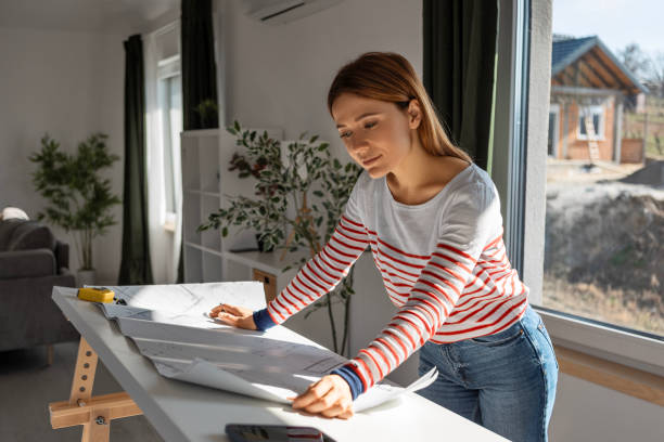 Woman With Design Plans in a Contemporary Workspace