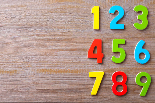 istock Colorful numbers on wooden table, flat lay. Space for text 2204287813