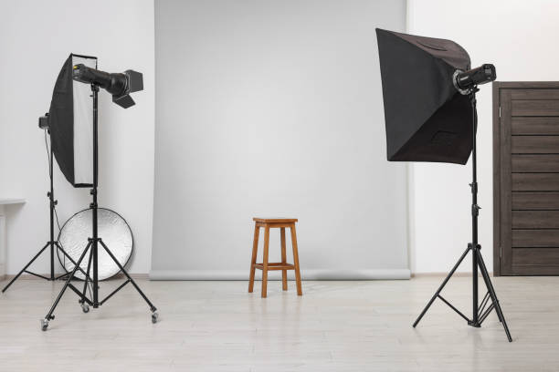 istock Empty stool surrounded by professional lighting equipment in photo studio 2204287881