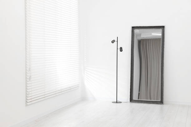 istock Stylish makeup room interior with long mirror and lamp. Space for text 2204287972
