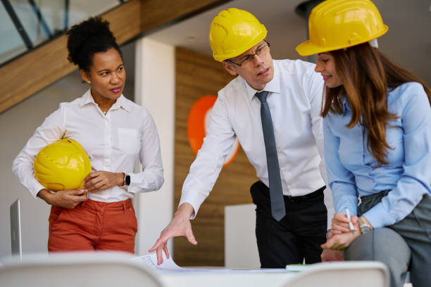istock Architects reviewing blueprints in modern office 2204288121