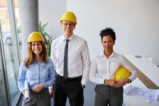 istock Team of architects smiling at camera in their office 2204288199