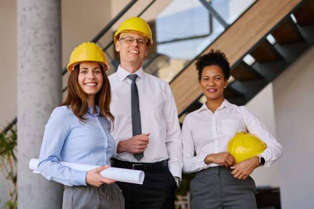 istock Team of architects smiling at camera in their office 2204288230