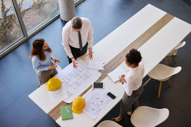 istock Architects analyzing blueprints in the office during a meeting 2204288446