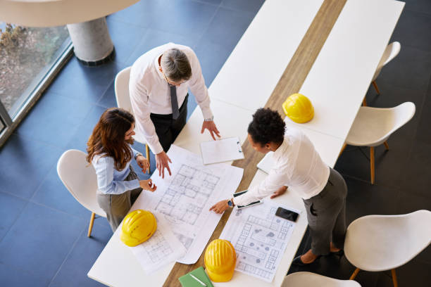 istock Architects analyzing blueprints in the office meeting room 2204288477